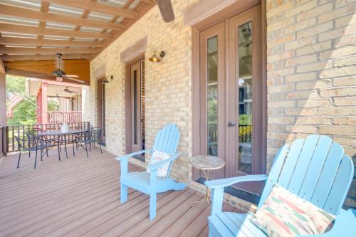 a porch with blue chairs and a table at Walk to Lake Home with Community Perks in Canadian! in Canadian