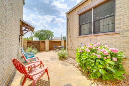 a patio with two chairs and a bush with pink flowers at Walk to Lake Home with Community Perks in Canadian! in Canadian