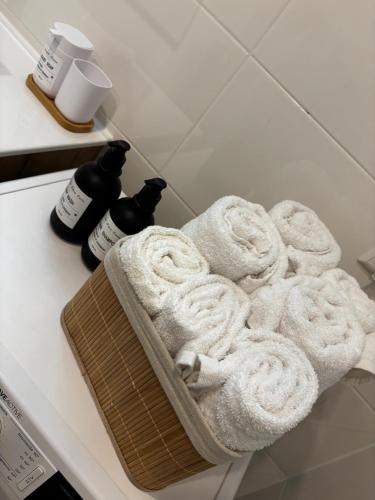 a basket of towels on a counter in a bathroom at Schwarzwaldwohnung Tannenglück in Alpirsbach