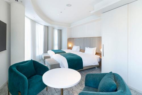 Postel nebo postele na pokoji v ubytování Hotel Comento Yokohama Kannai