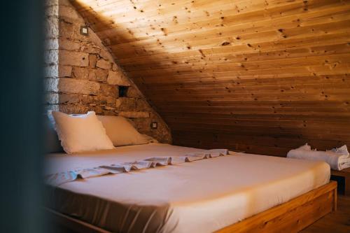 a bed in a room with a wooden ceiling at Family friendly house with a swimming pool Selca, Brac - 24224 in Selca
