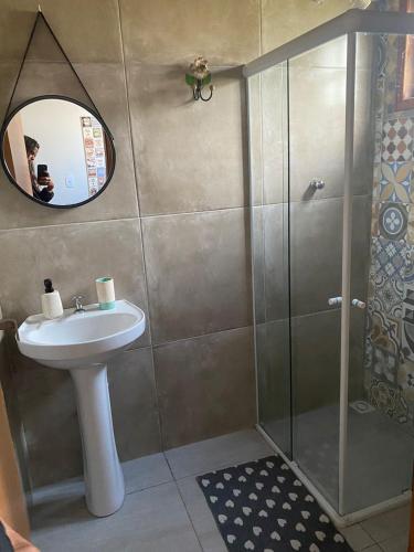 a bathroom with a sink and a shower at Chalés Praias do Sana in Macaé