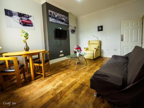 a living room with a couch and a table at Bucknall Lodge Hanley Room 2 Double Room En-suite in Stoke on Trent