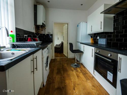 a kitchen with a sink and a counter top at Bucknall Lodge Hanley Room 2 Double Room En-suite in Stoke on Trent