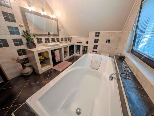 a large bathroom with a tub and a sink at Holiday home in Siofok - Balaton 19950 in Siófok