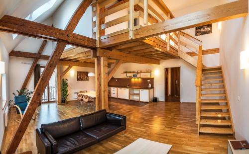 a living room with a couch and a staircase at Davidův mlýn in Staré Těchanovice