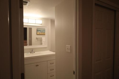 a bathroom with a sink and a mirror at Mariner East in Panama City Beach