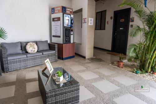 a lobby with a couch and a gas station at Hotel Boutique CasAguacate close to Airport, Pedregal, Centro de Convenciones de Costa Rica in Potrerillos