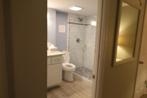 a bathroom with a toilet and a sink and a shower at Mariner East in Panama City Beach
