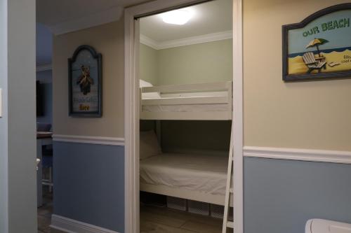 a bunk bed in a room with a mirror at Mariner East in Panama City Beach