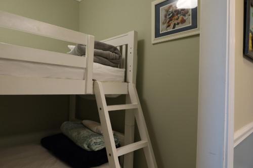 a bunk bed with a ladder in a room at Mariner East in Panama City Beach