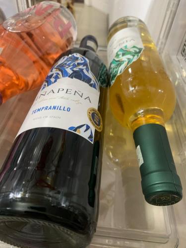two bottles of wine in a refrigerator at Hotel Boutique CasAguacate close to Airport, Pedregal, Centro de Convenciones de Costa Rica in Potrerillos