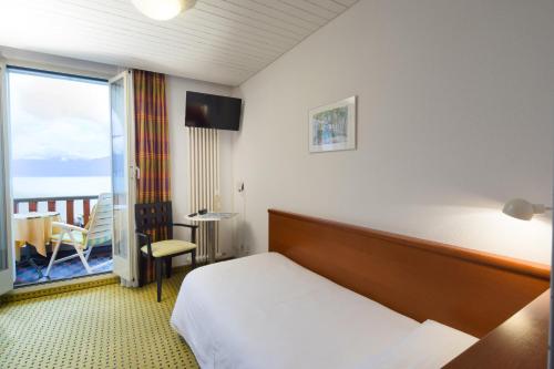 Ένα ή περισσότερα κρεβάτια σε δωμάτιο στο Piazza Ascona Hotel & Restaurants
