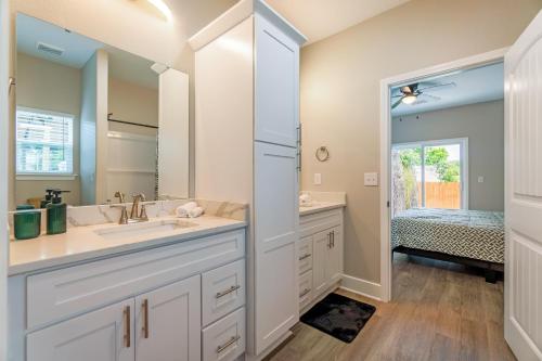 a bathroom with a sink and a mirror at Brand New Modern Luxury Duplex EV Ready in Pensacola