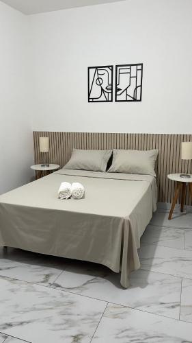 Ένα ή περισσότερα κρεβάτια σε δωμάτιο στο Casa Aconchegante no Centro