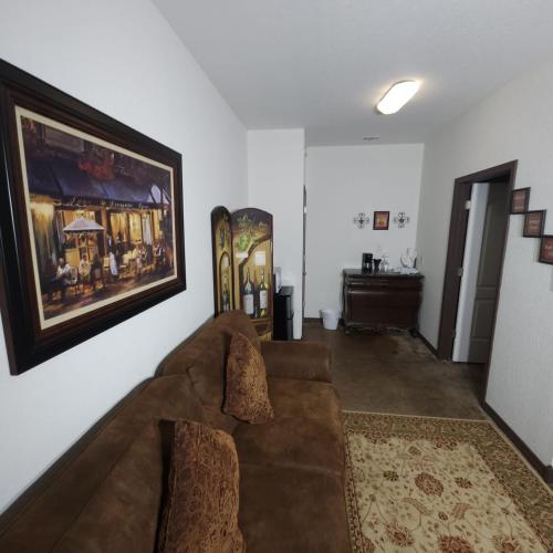a living room with a couch and a painting on the wall at Fredericksburg Escape Wineries & Hot Tub in Fredericksburg