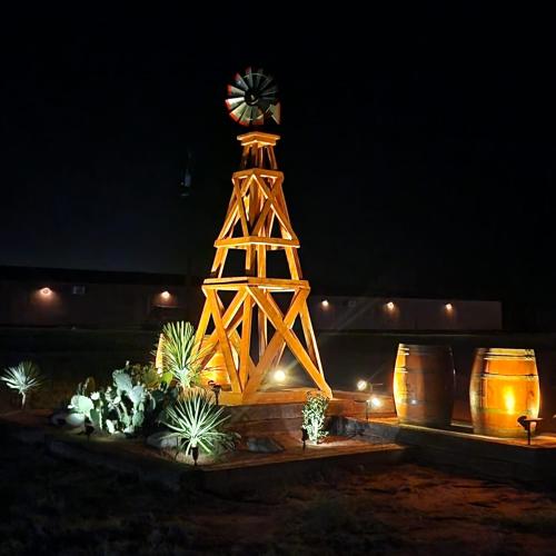 a tower with a clock on top of it at night at Fredericksburg Escape Wineries & Hot Tub in Fredericksburg