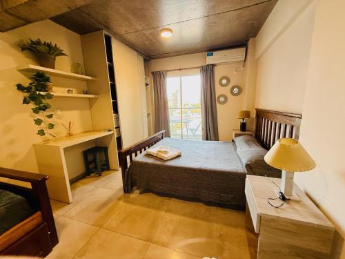 a small bedroom with a bed and a window at Departamento amplio con pileta y Parrilla barrio norte in San Miguel de Tucumán