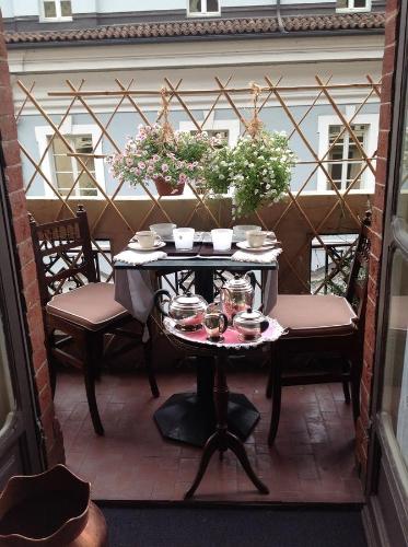 a table on a balcony with dishes on it at A Casa Armenia B&B in Turin