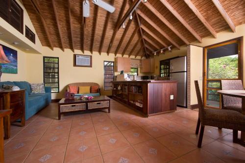a living room with a couch and a table at New Moon Escape - Affordable, Private Cottage with a Pool, WIFI and AC in Coral Bay