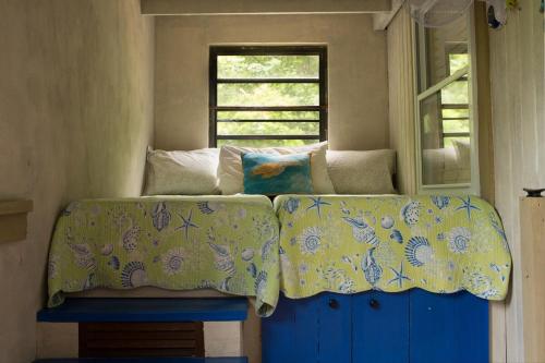 a bed in a room with a window at New Moon Escape - Affordable, Private Cottage with a Pool, WIFI and AC in Coral Bay