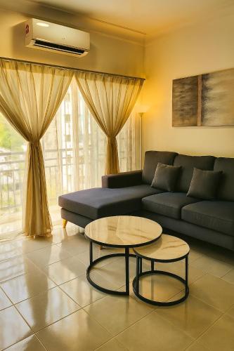 a living room with a couch and a table at Angsana Raintree Batu Caves with balcony 3Bedroom 2Bathroom in Batu Caves