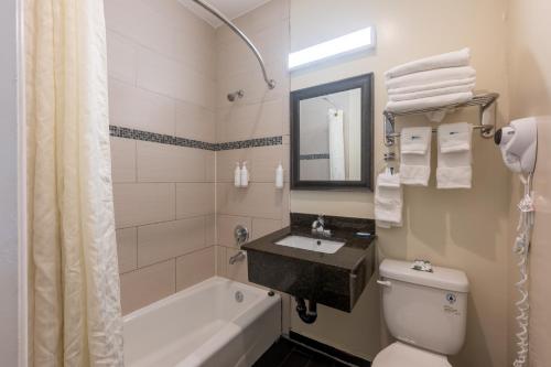 a bathroom with a tub and a toilet and a sink at Hollywood City Inn in Los Angeles