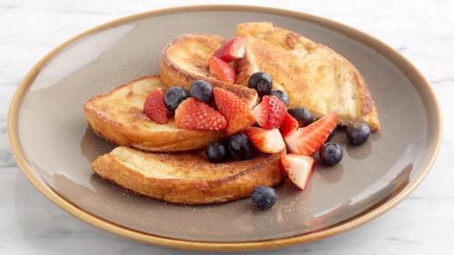 a plate of toast with fruit on it at Holiday Inn Stoke on Trent M6 Jct15 by IHG in Stoke on Trent