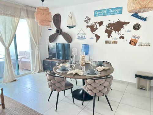 a dining room with a table and a world map on the wall at Atmospheric apartment with a beautiful view of the swimming pool in Bayahibe