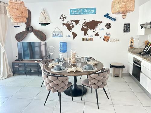 a kitchen with a table with chairs and a map on the wall at Atmospheric apartment with a beautiful view of the swimming pool in Bayahibe