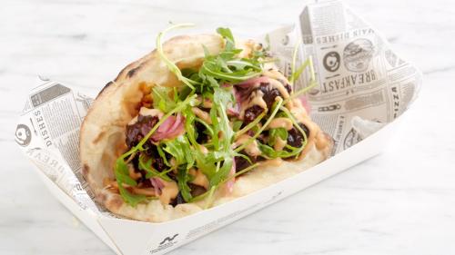 a sandwich in a paper container with salad on it at Holiday Inn Leeds-Wakefield M1 Jct40 by IHG in Wakefield