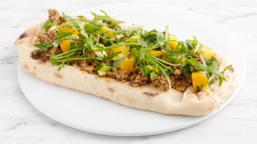 a pizza on a plate on a white plate at Holiday Inn Taunton M5, Jct25 by IHG in Taunton