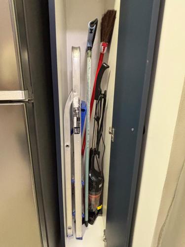 a group of tools are hanging on a door at Flat Assinado e Sofisticado in Vitória