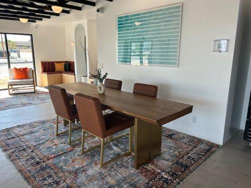 a wooden table and chairs in a living room at Acres Landing in Desert Hot Springs