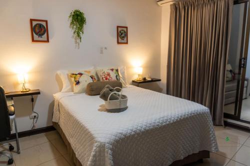 a bedroom with a bed with a basket on it at Hotel Boutique CasAguacate close to Airport, Pedregal, Centro de Convenciones de Costa Rica in Potrerillos