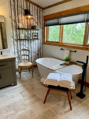 a bathroom with a bath tub and a chair at The Penthouse in Ennis