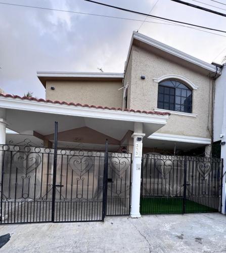 a house with a gate with hearts on it at Casa Luna in Ciudad Madero