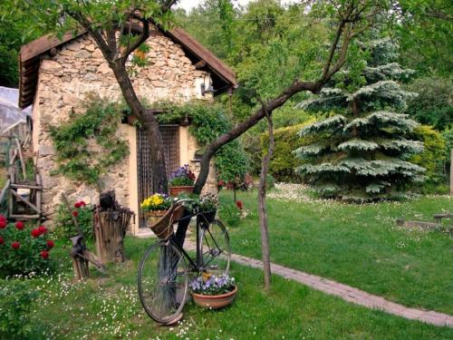 a bike parked next to a house with a christmas tree at Holiday Home in Liguria near Barbottina Forest in Calizzano