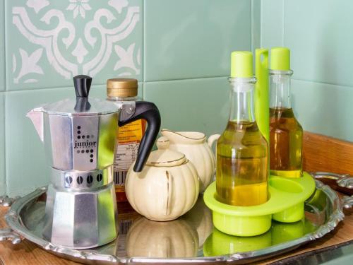 a counter with two bottles of oil and a blender at Holiday Home in Liguria near Barbottina Forest in Calizzano