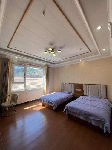 Katil atau katil-katil dalam bilik di Jinshanling Great Wall Longteng Farmhouse