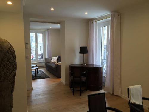 a living room with a table and a couch at Bellechasse Apartments in Paris