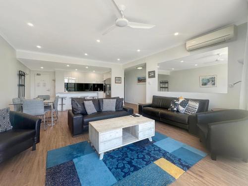 a living room with couches and a coffee table at Unit 30 - Avoca Palms Resort in Avoca Beach