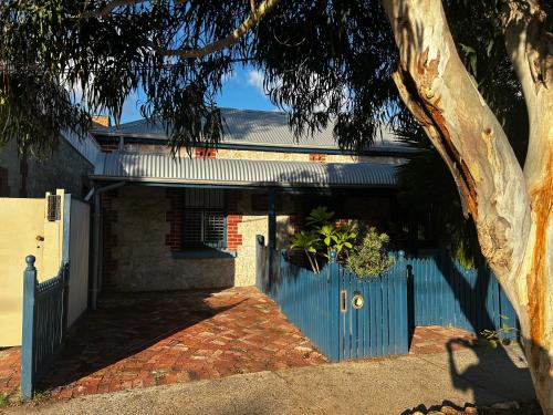 a blue gate in front of a house at South Terrace Studio - Walk to Everything ! in South Fremantle