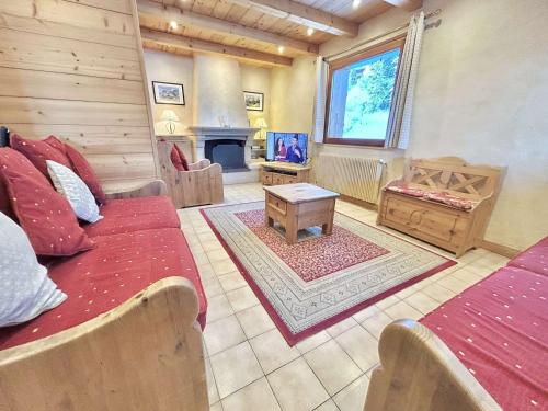 a living room with a couch and a fireplace at Chalet indépendant avec spa, sauna et cheminée à Notre-Dame-de-Bellecombe - 10 pers - FR-1-595-102 in Notre-Dame-de-Bellecombe