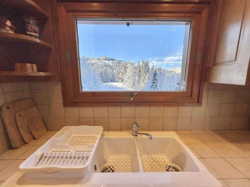 a kitchen sink with a view of a snow covered mountain at Chalet indépendant avec spa, sauna et cheminée à Notre-Dame-de-Bellecombe - 10 pers - FR-1-595-102 in Notre-Dame-de-Bellecombe