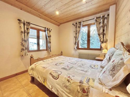 a bedroom with a bed and two windows at Chalet indépendant avec spa, sauna et cheminée à Notre-Dame-de-Bellecombe - 10 pers - FR-1-595-102 in Notre-Dame-de-Bellecombe