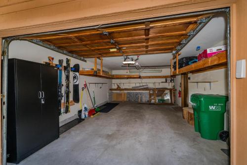 a garage with a garage door open to a room with skis at Mountain Getaway - Lake Tahoe - Incline Village - Private Garage in Incline Village