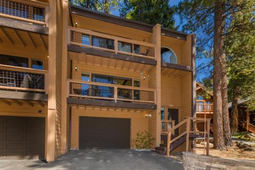 a large house with a garage and a tree at Mountain Getaway - Lake Tahoe - Incline Village - Private Garage in Incline Village