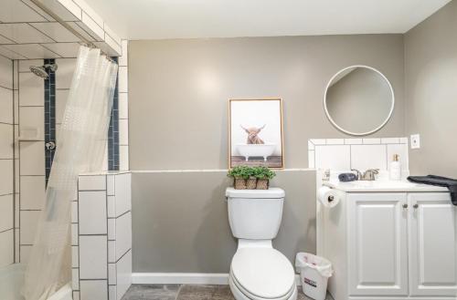 a bathroom with a toilet and a sink and a mirror at Large Group, Family, Bachelorette Parties, Handicap Accessible, Long Term Stays Welcome in Bay City