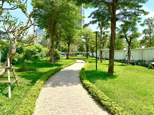 a brick path in a park with trees at Delux Stu Apt In Vinhomes, Close to JW Marriott, Keangnam and My Dinh in Hanoi